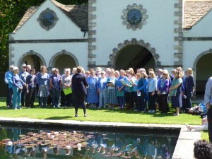 Coastal Voices and Bangor Community Choir singing together by the Pin Mill